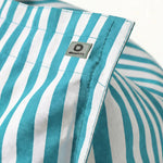 Détail tissu pouf turquoise