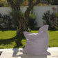 Giant XXL grey pebble pouf for outdoor use, waterproof and removable cover, perfect for garden or patio relaxation.